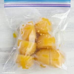 A top view of freezed mangoes in a plastic bag