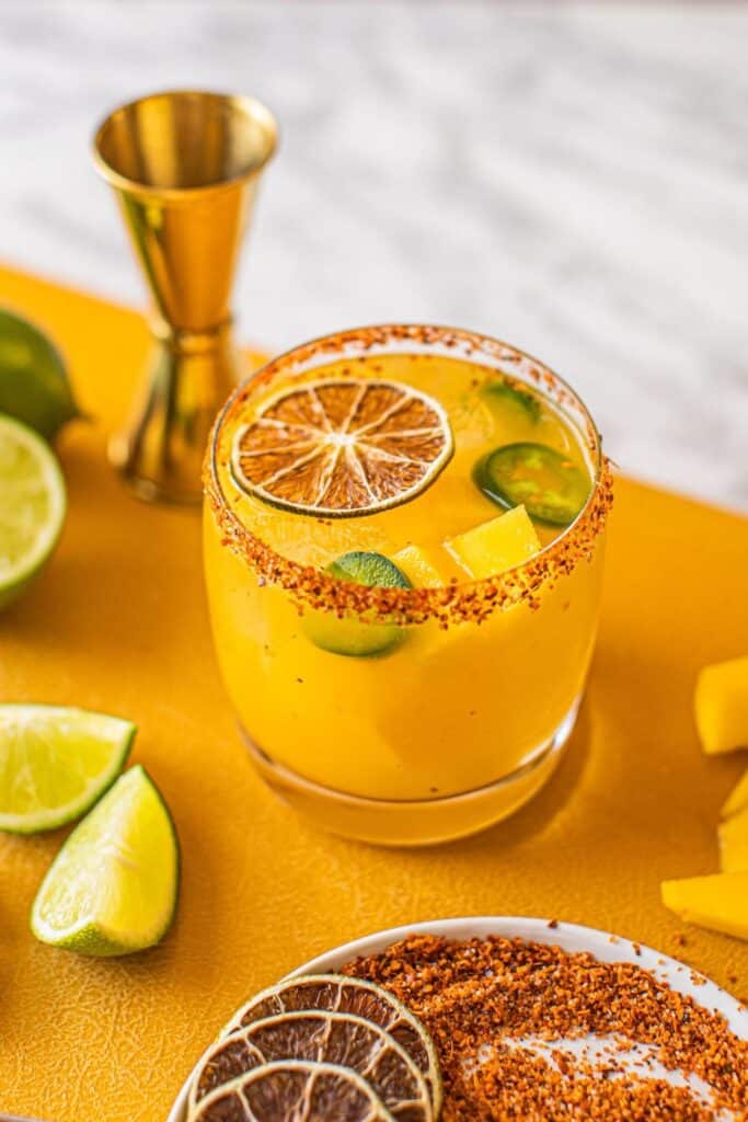 Spicy Mango Margarita beautifully garnished glass with jalapenos floating on top