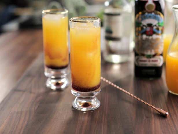 two glasses of mango tequila on a wooden table