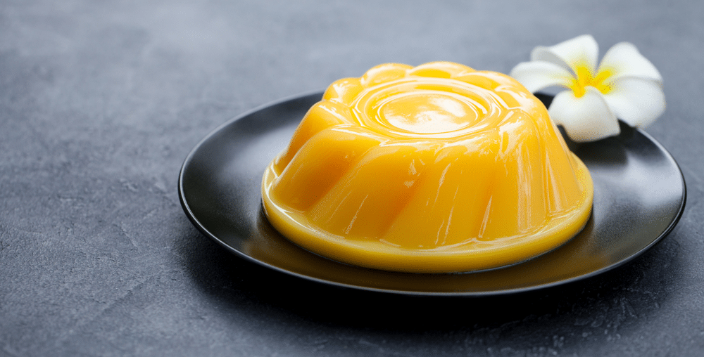 Mango pudding jelly dessert on black plate