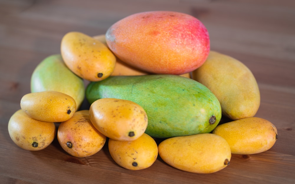 Stack of several varieties of Mangoes of different size and colors