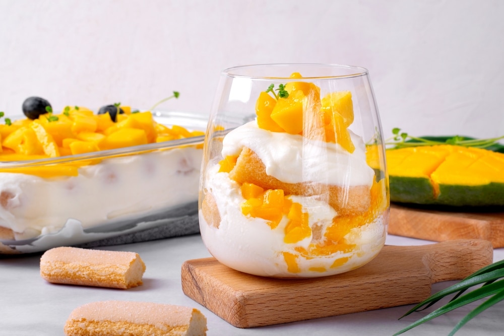 Trifle Dessert With Mango And Ladyfinger Cookies Served In A glass