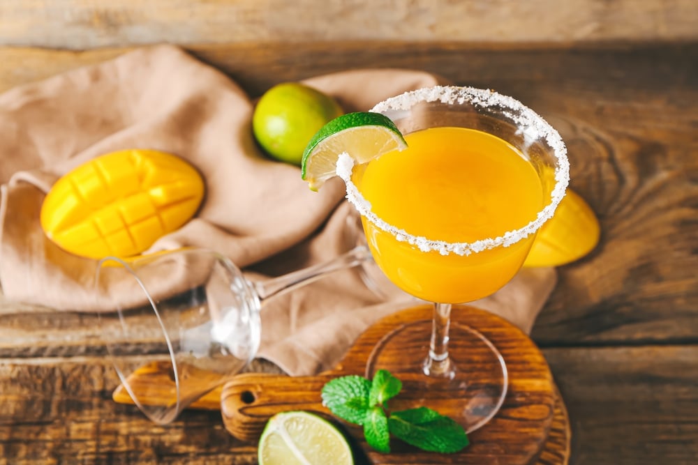 Glass Of Tasty Mango Margarita And Ingredients On Wooden Background