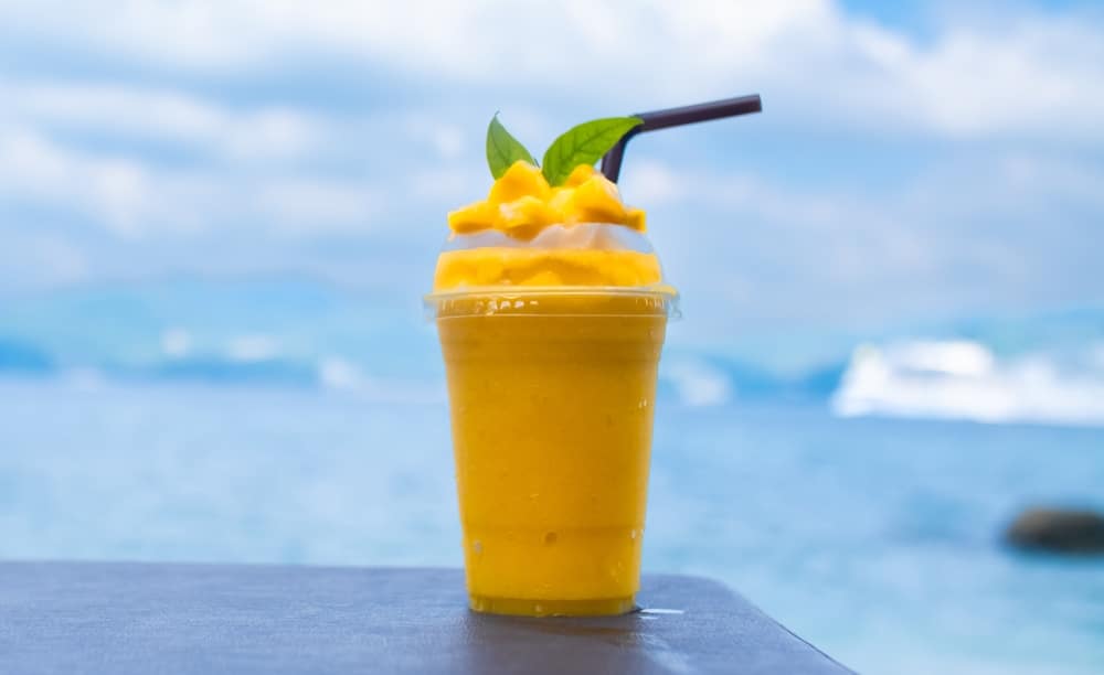 Smoothie Made From Fresh Mango Fruits Against The Backdrop Of sea