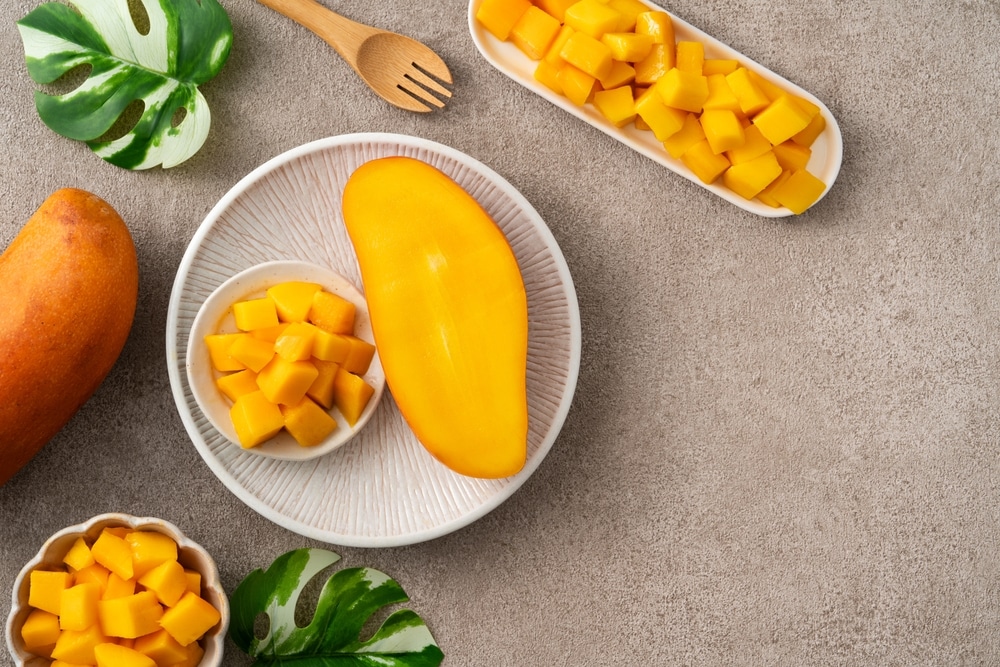 Fresh Chopped Diced Mango Cubes On Gray Table Background With